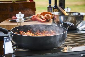 Cooking on a side burner on a outdoor kitchen